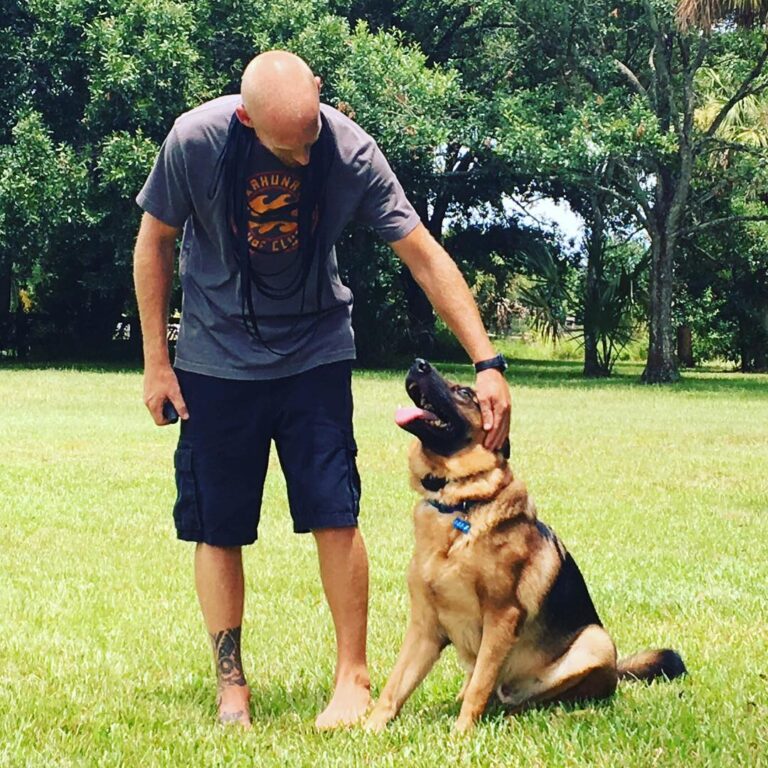 Rick and Shepard posing for a picture in a lawn
